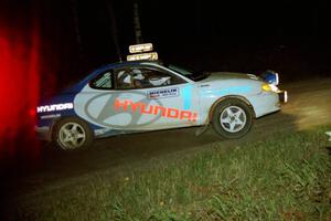 The Paul Choiniere / Tom Grimshaw Hyundai Tiburon sets up for a 90-right at night.