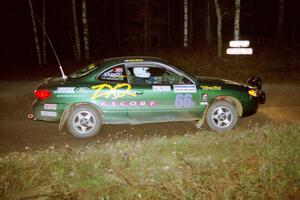 Tad Ohtake / Bob Martin set up for a 90-right at night in their Ford Escort ZX2.