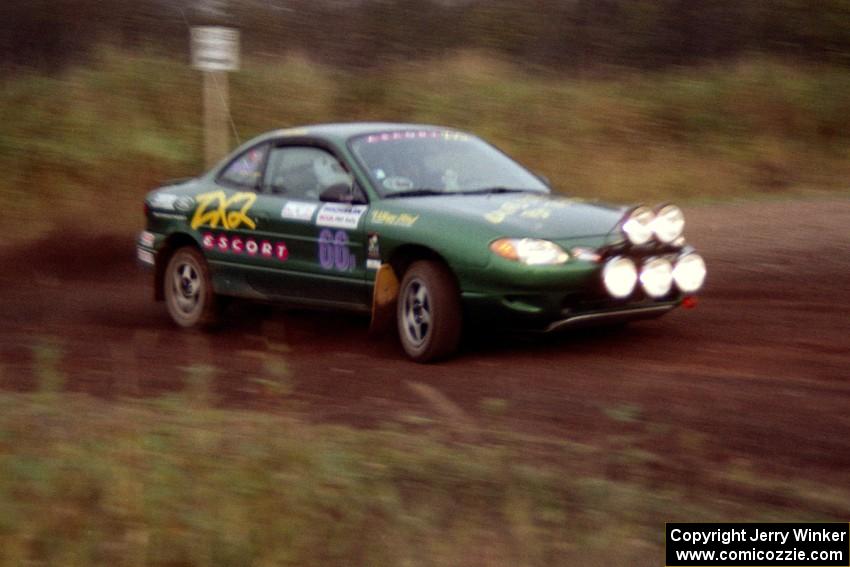 Tad Ohtake / Bob Martin take a hard-right in their Ford Escort ZX2 on the practice stage.