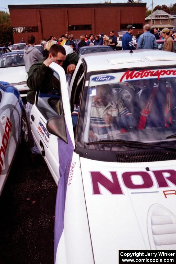 Lance Smith belts into the Ford Escort Cosworth RS he and Carl Merrill shared.