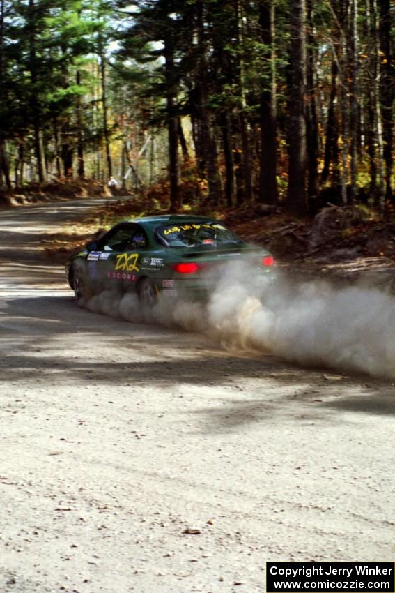 Tad Ohtake / Bob Martin drift their Ford Escort ZX2 through the final corner of SS2.