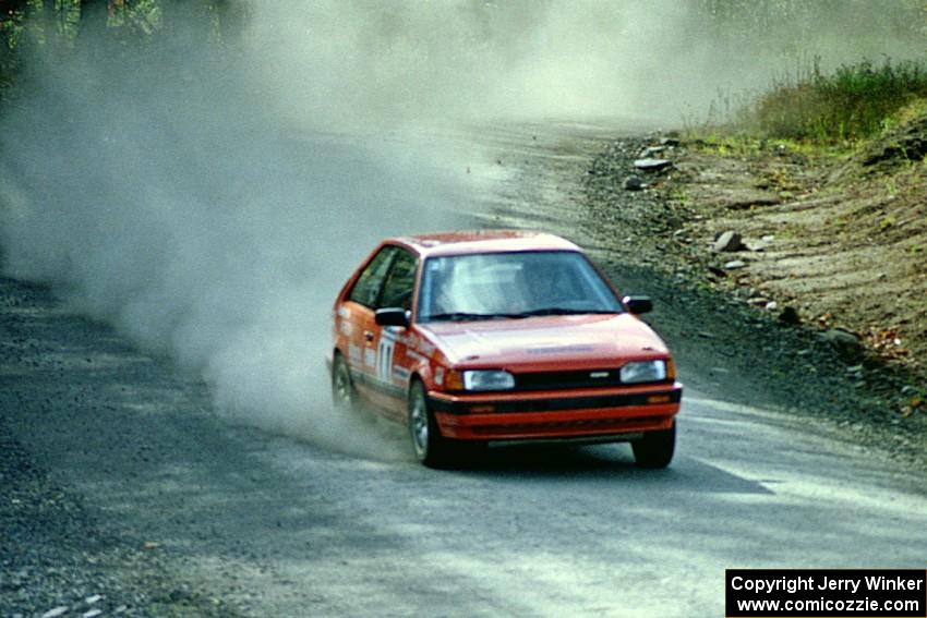 Gail Truess / Nancy Redner at speed in their Mazda 323GTX near the finish of SS2.