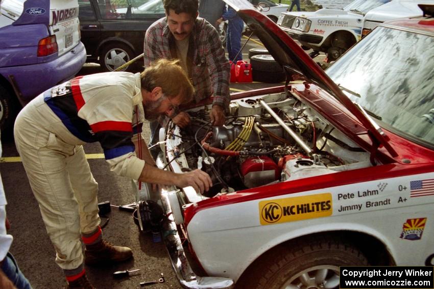 Jimmy Brandt fidgets with the engine on the Datsun 510 he shared with Pete Lahm.