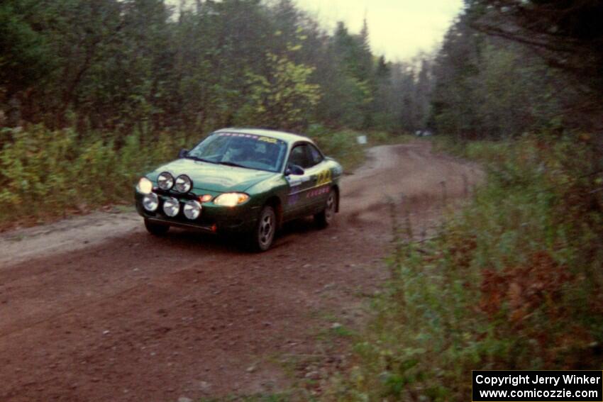 Tad Ohtake / Bob Martin at speed in their Ford Escort ZX2 on Menge Creek II.