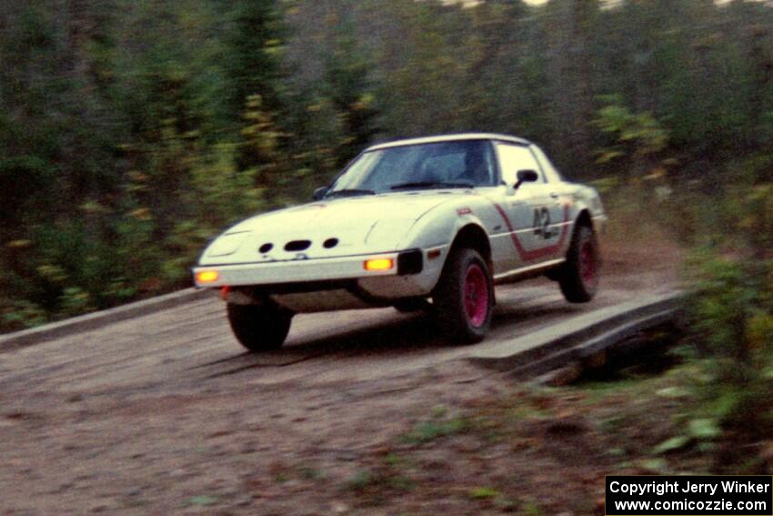 Craig Kazmierczak / Diane Sargent bring their Mazda RX-7 across the final bridge of Menge Creek II.