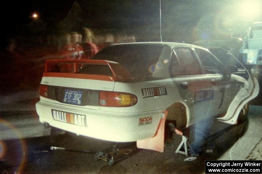 The crew of the TAD team go to work on the Henry Joy IV / Michael Fennell Mitsubishi Lancer Evo II at Kenton service.