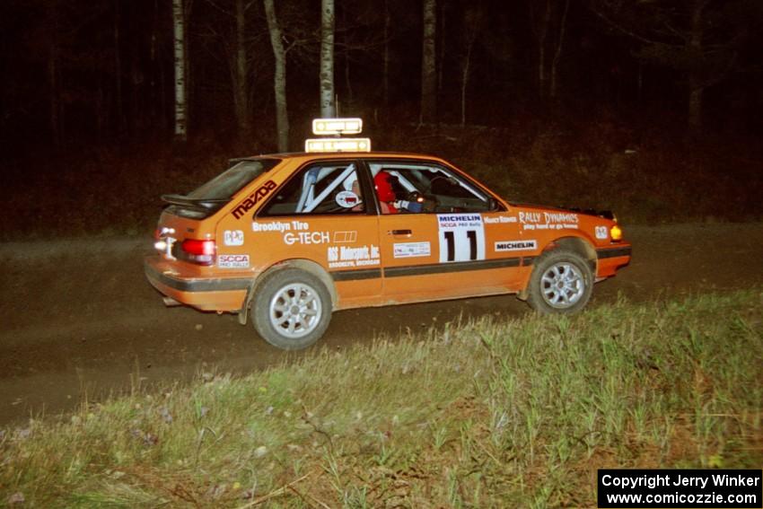 Gail Truess / Nancy Redner at speed through a 90-right at night in their Mazda 323GTX.