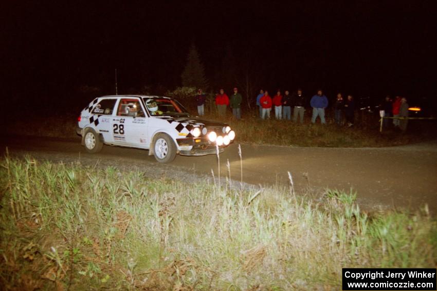 Richard Losee / Kent Livingston VW GTI at speed through a 90-right at night in their Mazda 323GTX.