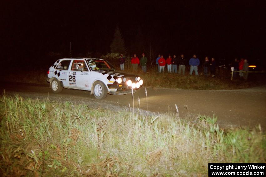 Richard Losee / Kent Livingston VW GTI at speed through a 90-right at night in their Mazda 323GTX.