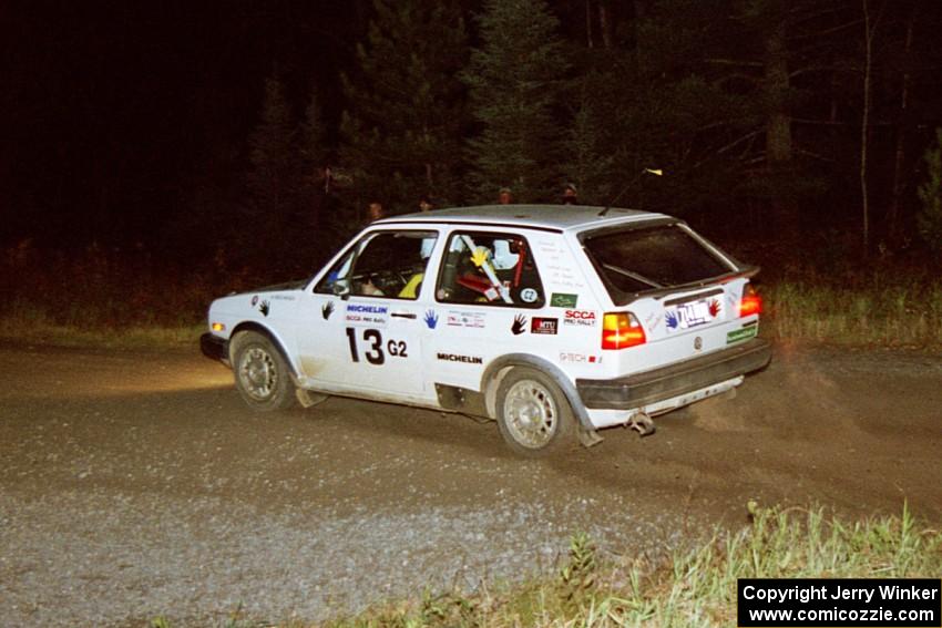 Wayne Prochaska / Annette Prochaska bring their VW Golf through a 90-right at night.