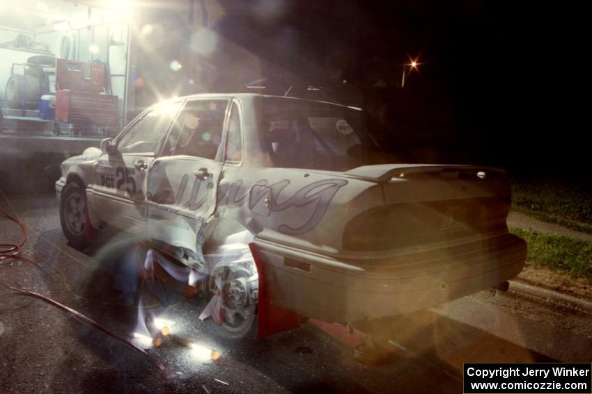 A left-rear tire is swapped on the Bill Driegert / Hishin Shim Mitsubishi Galant VR4 at the second Kenton service.