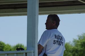 A corner worker at turn two keeps an eye on traffic.