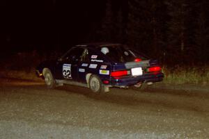 Brian Scott / David Watts drift their Dodge Shelby Charger through a 90-right at night.