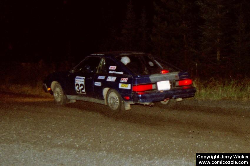 Brian Scott / David Watts drift their Dodge Shelby Charger through a 90-right at night.