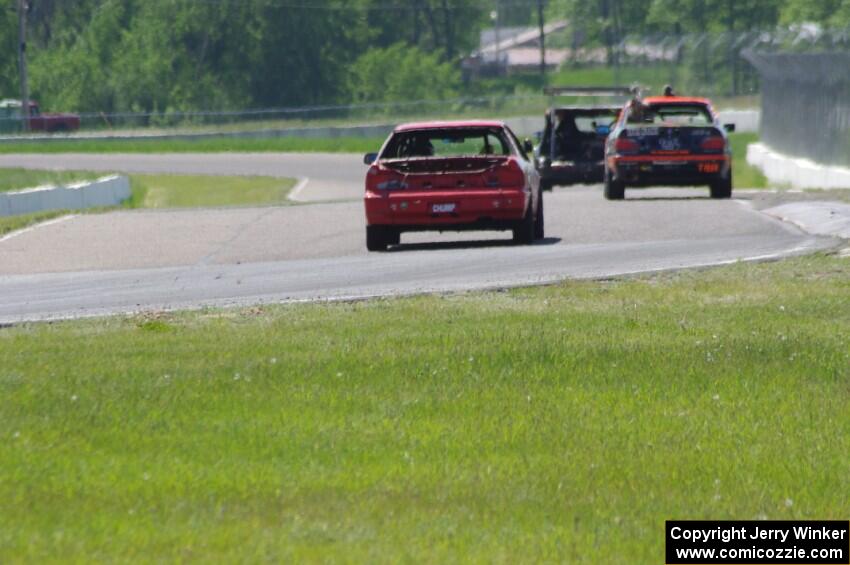 Brake Dusters BMW 540 leads Tubby Butterman BMW 325 and Trump Chump Honda Prelude out of turn 6