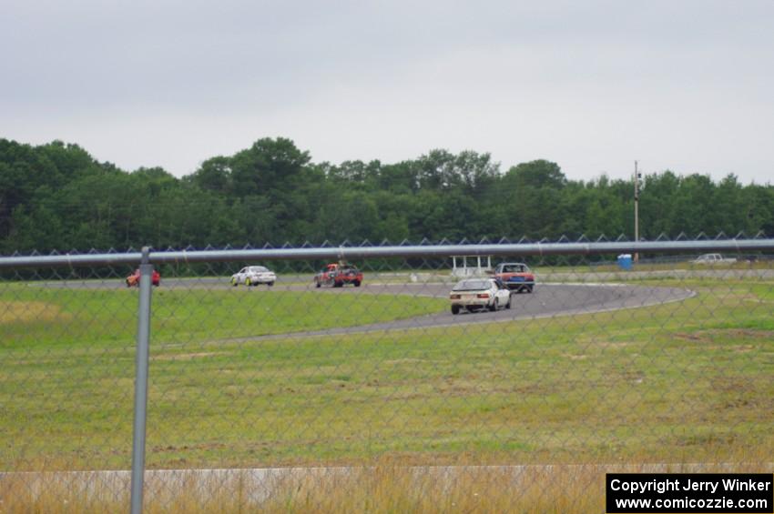 Five cars head out of turn 4 into turn 5