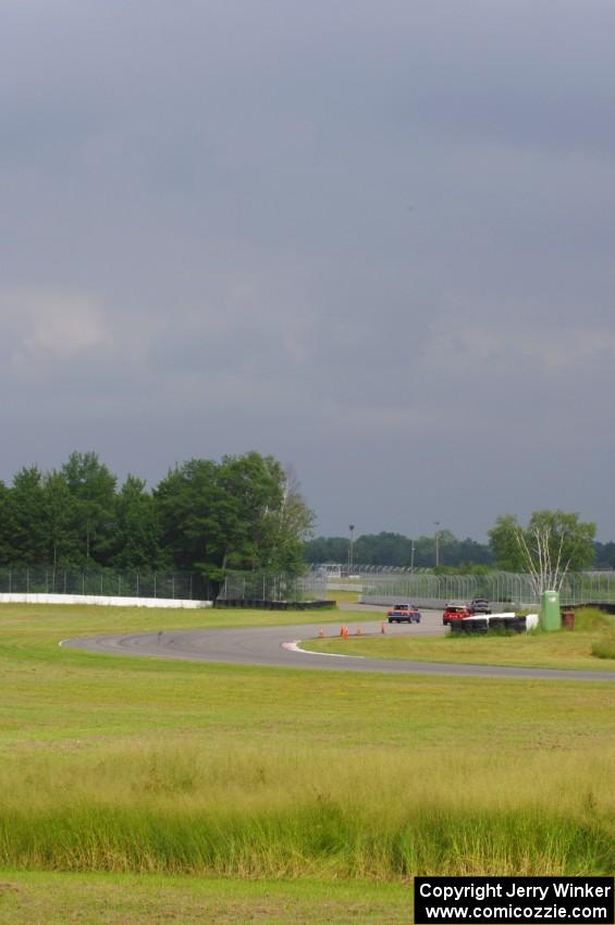 Hazy skies as three cars exit the carousel