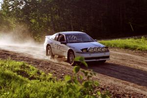 Chris Czyzio / Eric Carlson at speed over the crest at the crossroads in their Mitsubishi Eclipse GSX.