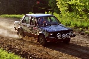 Eric Schroeder / Jennie Mynhier drive their VW Jetta over the crossroads crest and get light.