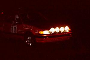 Gail Truess / Pattie Hughes in darkness in their Mazda 323GTX at the crossroads.