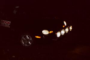 Evan Moen / Ron Moen drive their Dodge Neon through the crossroads at night.