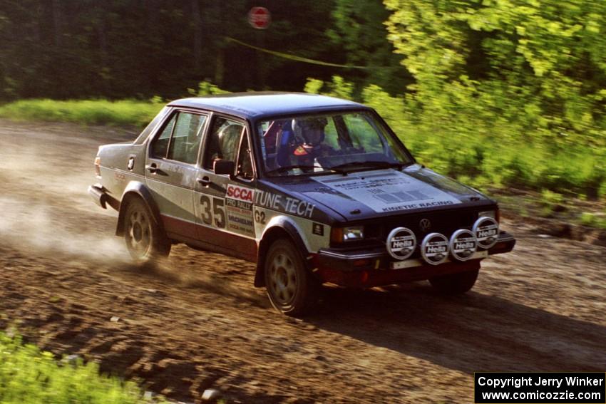 Eric Schroeder / Jennie Mynhier drive their VW Jetta over the crossroads crest and get light.