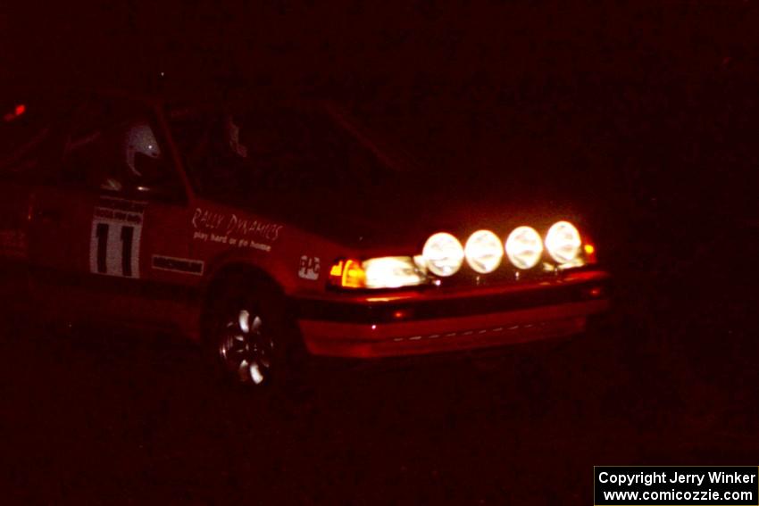 Gail Truess / Pattie Hughes in darkness in their Mazda 323GTX at the crossroads.