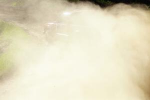 Jim Cox / Scott Parrott make a dust cloud as they drift through an uphill left on SS1 in their Chevy S-10.