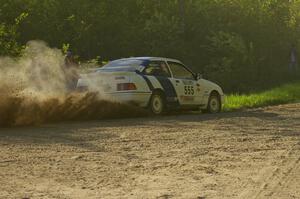 Colin McCleery / Nancy McCleery drift through a 90-left in their Ford Sierra XR8 on SS2.