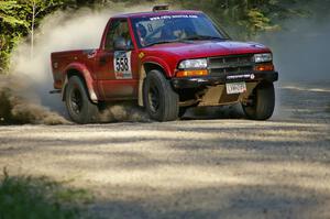 Jim Cox / Scott Parrott kick up gravel as they set up for a hairpin left on SS3 in their Chevy S-10.