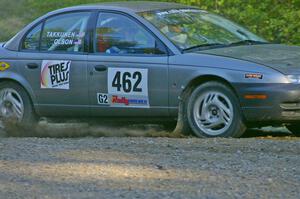 Mike Olson / Jason Takkunen set up for a hairpin on SS3 in their Saturn SL2.