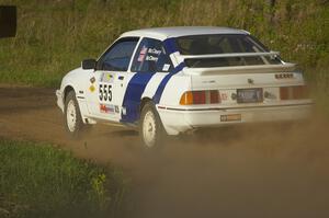 Colin McCleery / Nancy McCleery make a 90-left onto Parkway Forest Road in their Ford Sierra XR8 on SS4.
