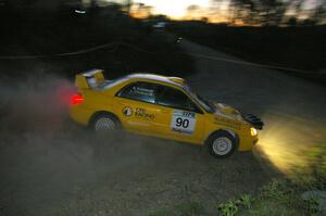 Lauchlin O'Sullivan / Scott Putnam drift beautifully through a downhill right on SS5 in their Subaru WRX STi at sundown.