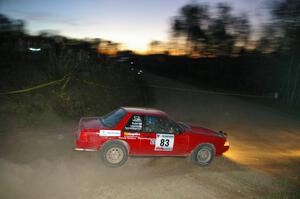 Mark Utecht / Rob Bohn Ford Mustang at speed through a downhill right on SS5 at sundown.