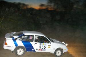 Colin McCleery / Nancy McCleery wade through the dust at a dowhill right in their Ford Sierra XR8.
