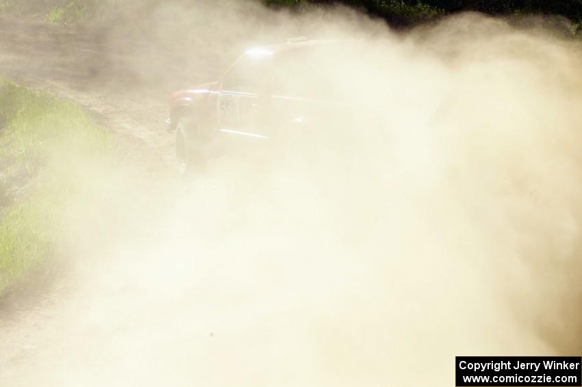 Jim Cox / Scott Parrott make a dust cloud as they drift through an uphill left on SS1 in their Chevy S-10.
