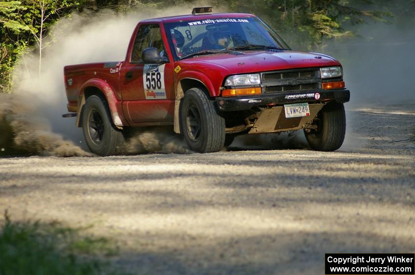 Jim Cox / Scott Parrott kick up gravel as they set up for a hairpin left on SS3 in their Chevy S-10.