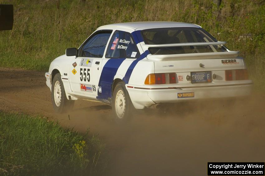 Colin McCleery / Nancy McCleery make a 90-left onto Parkway Forest Road in their Ford Sierra XR8 on SS4.