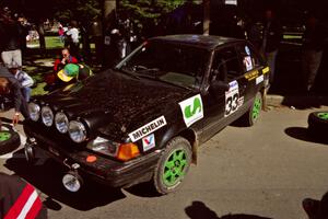 Tom Ottey / Pam McGarvey Mazda 323GTX at the green during the midday break