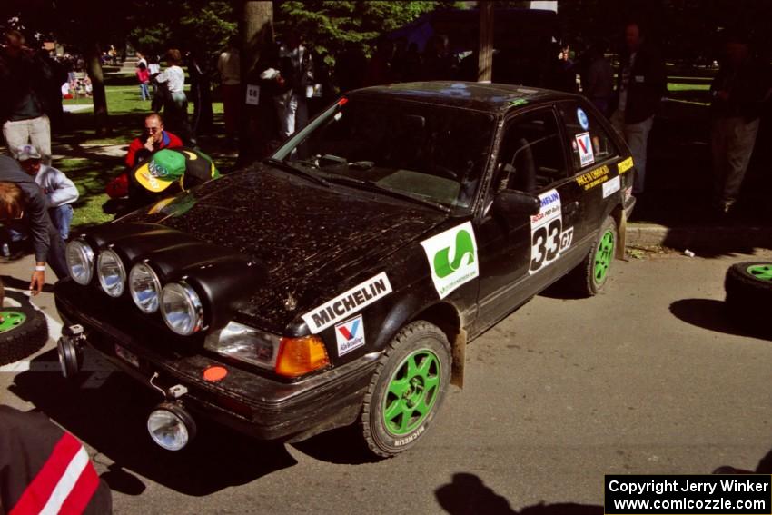 Tom Ottey / Pam McGarvey Mazda 323GTX at the green during the midday break