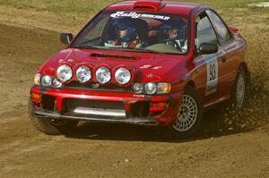 Bob Olson / Ryan Johnson throw gravel on SS1 at the Bemidji Speedway in their Subaru Impreza.