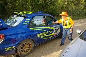 Barbara Steencken hands the timecard back to Travis Pastrana / Christian Edstrom Subaru WRX STi at the finish control of SS2.