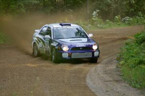 Tanner Foust / Chrissie Beavis Subaru WRX at a fast left-hander near the end of SS2.