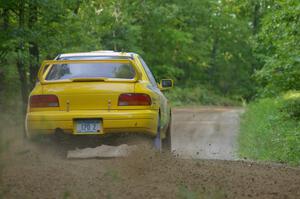 Mike Hurst / Russ Norton Subaru Impreza crests a hill near the finish of SS2.