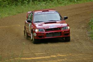 Erik Schmidt / Mike Rose at speed through a fast left-hander on SS2 in their Subaru Impreza.