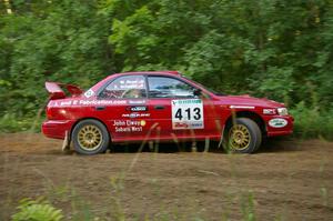 Erik Schmidt / Mike Rose get a little to wide at a hard right-hand hairpin on SS3 in their Subaru Impreza.