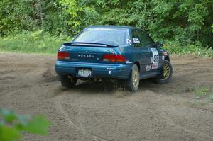 Martin Menning / Ryan Schnell Subaru Impreza at a hairpin on SS3.