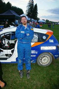 Eric Burmeister stands next to his Mazda Mazdaspeed 3 that he and Dave Shindle had a transmission go out on in the early stages.