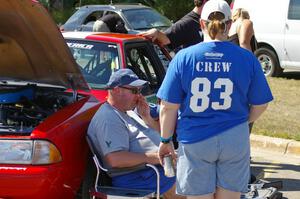 Mary Utecht, Mark Utecht, and Mike Hurst take a breather in front of Mark's Ford Mustang at parc expose.