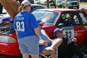 Mary Utecht, Mark Utecht, and Mike Hurst take a breather in front of Mark's Ford Mustang at parc expose.